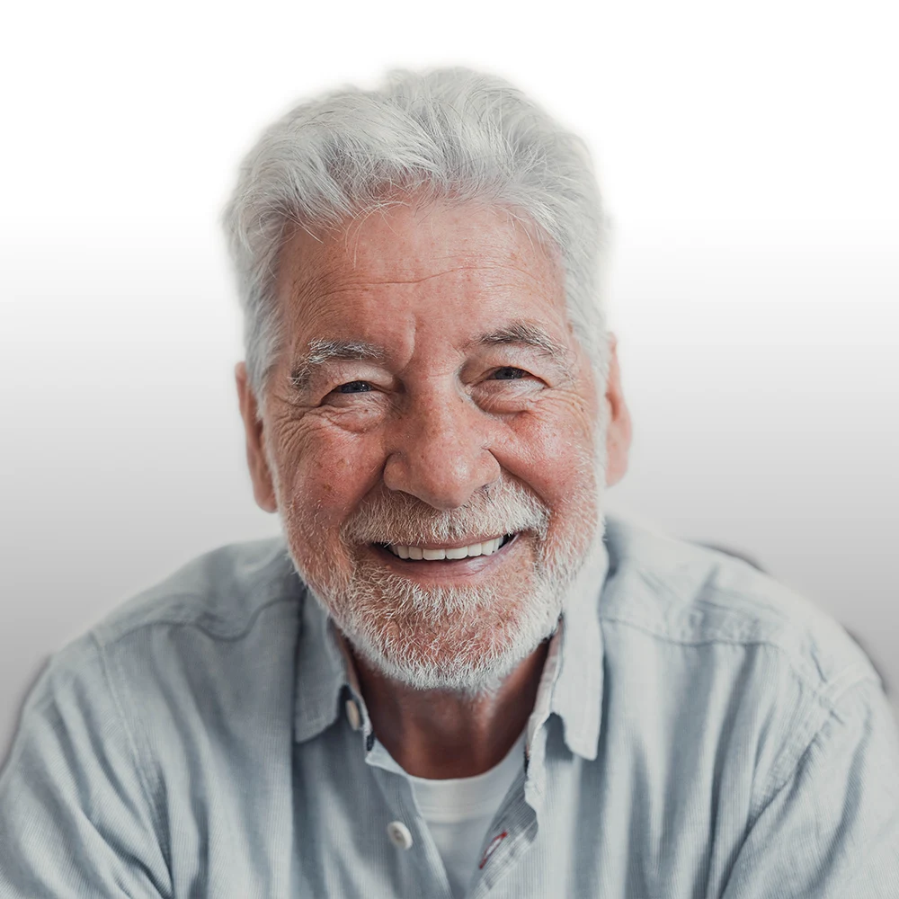 Man wearing dentures, smiling confidently